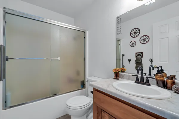 a white toilet sitting next to a bathroom sink