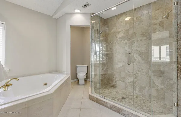 a bathroom with a bathtub and a shower