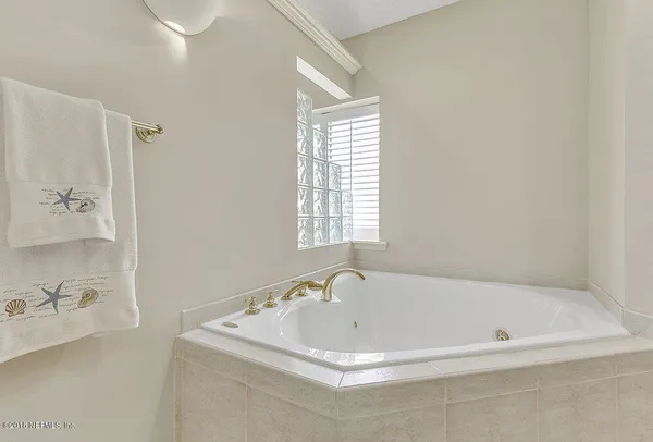 a white bath tub sitting next to a window