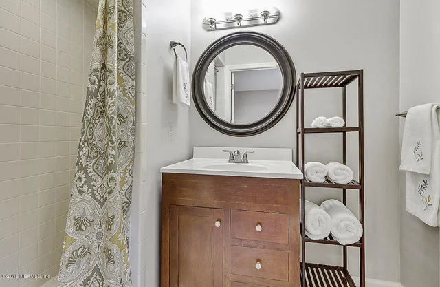 a bathroom with a sink a vanity and a mirror