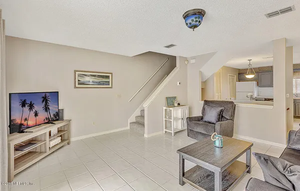 a living room with furniture and a rug