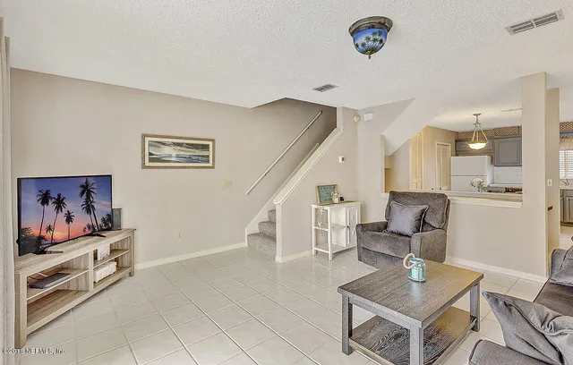 a living room with furniture and a rug
