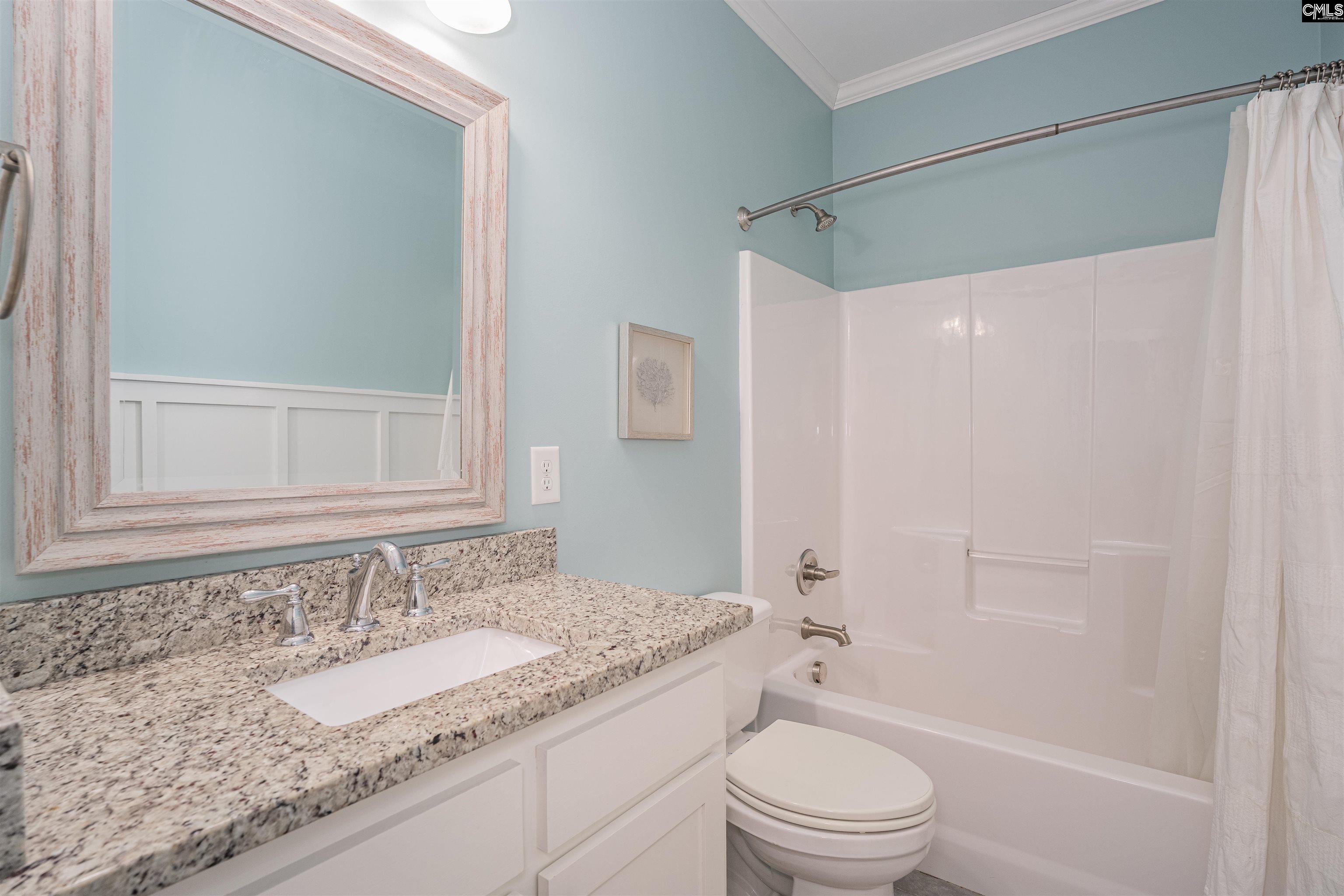 649 Sandbar Road Chapin, SC 29036 - Photo 18 of 40 a bathroom with a granite countertop sink toilet and shower