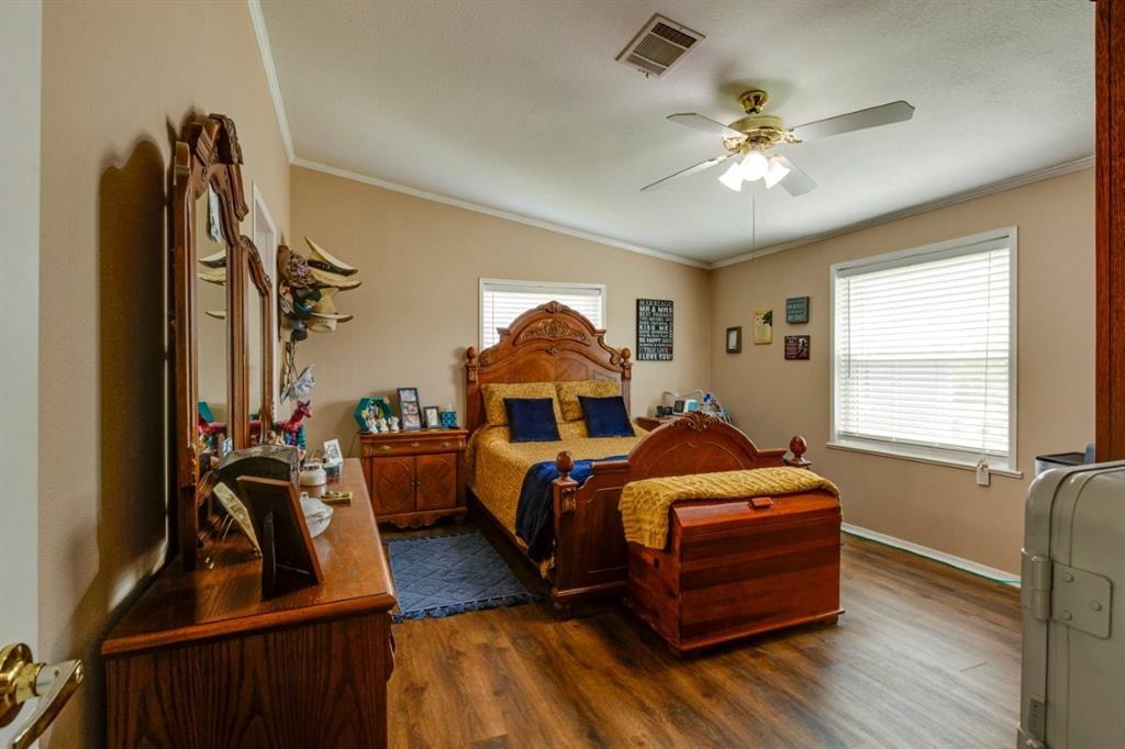 4880 Whitehead Road Midlothian, TX 76065 - Photo 15 of 36 a bedroom with furniture and a chandelier