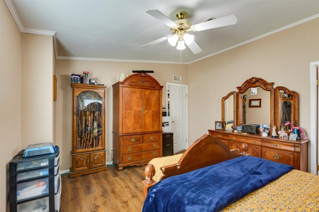 4880 Whitehead Road Midlothian, TX 76065 - Photo 16 of 36 a bedroom with a bed and a chandelier