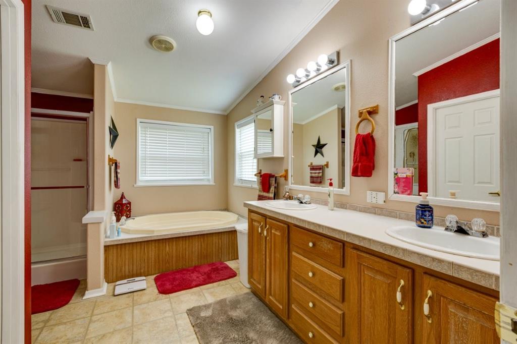 4880 Whitehead Road Midlothian, TX 76065 - Photo 17 of 36 a bathroom with a tub sink and mirror