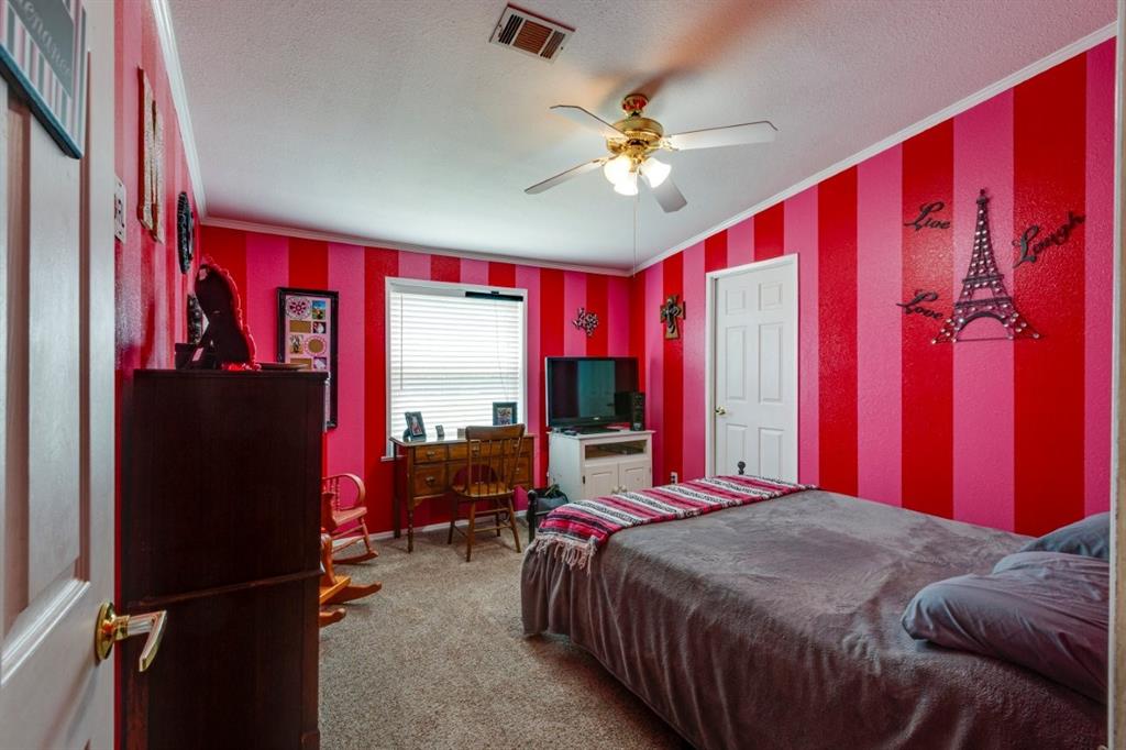 4880 Whitehead Road Midlothian, TX 76065 - Photo 20 of 36 a bed sitting in a bedroom next to a window