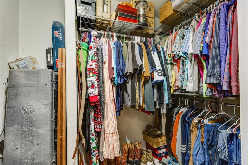4880 Whitehead Road Midlothian, TX 76065 - Photo 23 of 36 a view of walk in closet with clothes