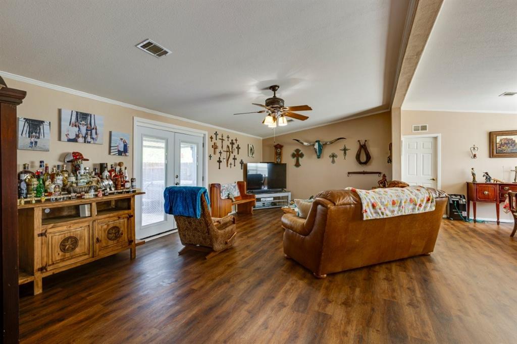 4880 Whitehead Road Midlothian, TX 76065 - Photo 9 of 36 a living room with furniture and wooden floor