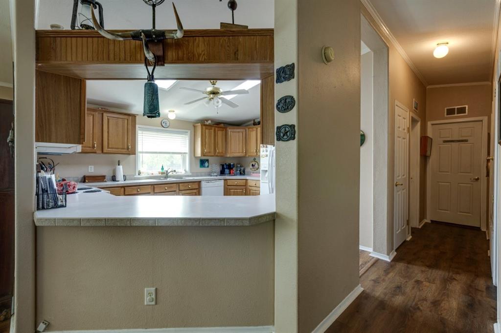 4880 Whitehead Road Midlothian, TX 76065 - Photo 10 of 36 a view of a kitchen with stainless steel appliances granite countertop cabinets and a sink