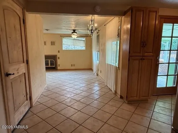 a view of a refrigerator in kitchen and a window