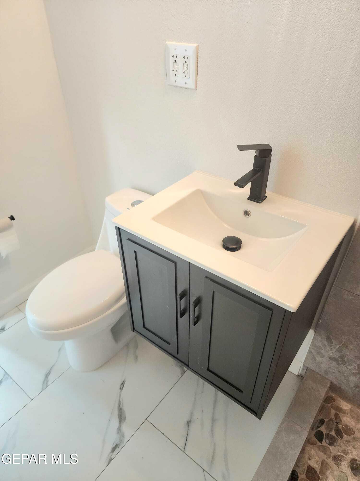 5845 Threadgill Avenue El Paso, TX 79924 - Photo 26 of 50 a bathroom with a toilet sink and mirror