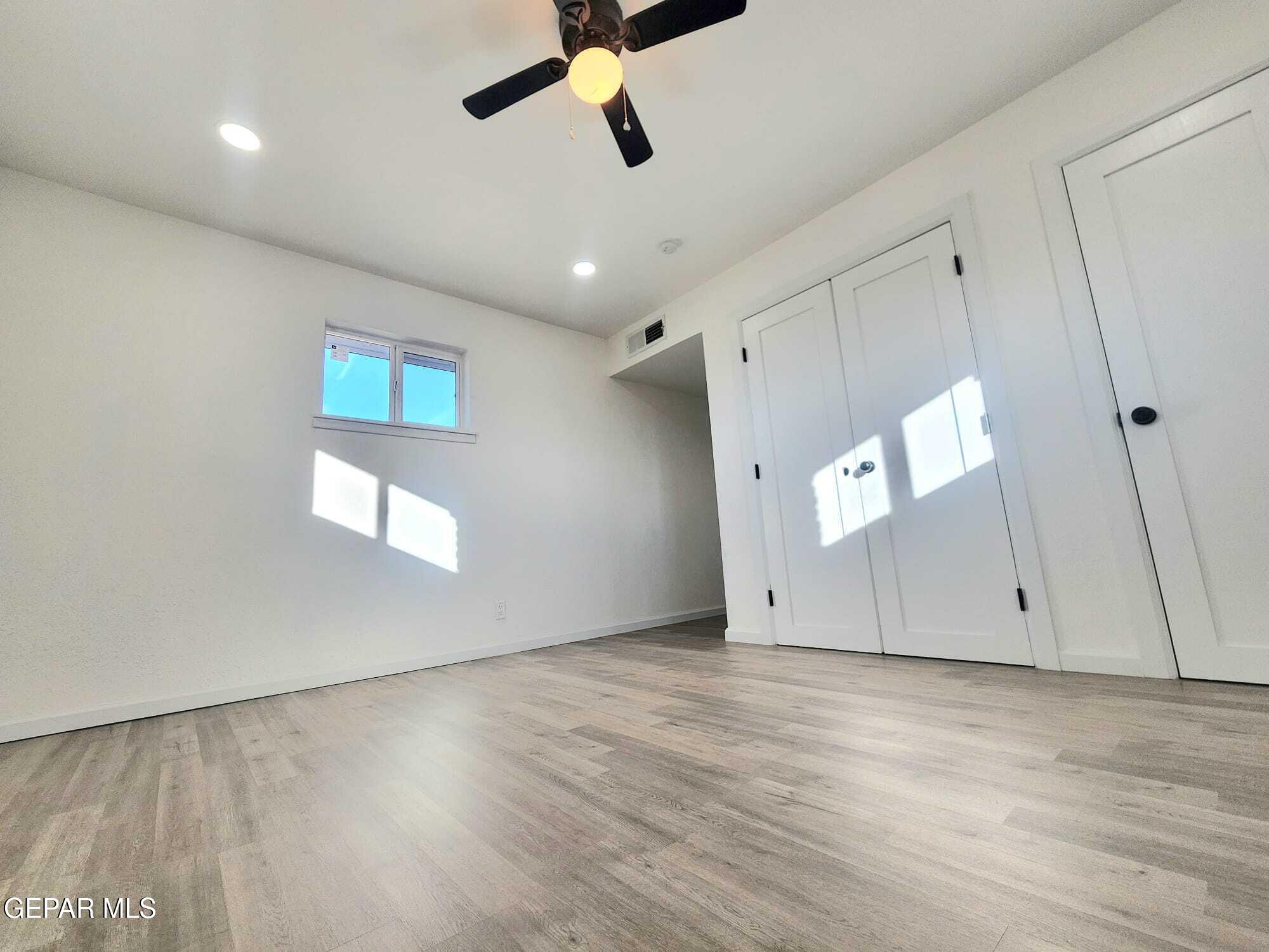 5845 Threadgill Avenue El Paso, TX 79924 - Photo 31 of 50 an empty room with wooden floor and windows