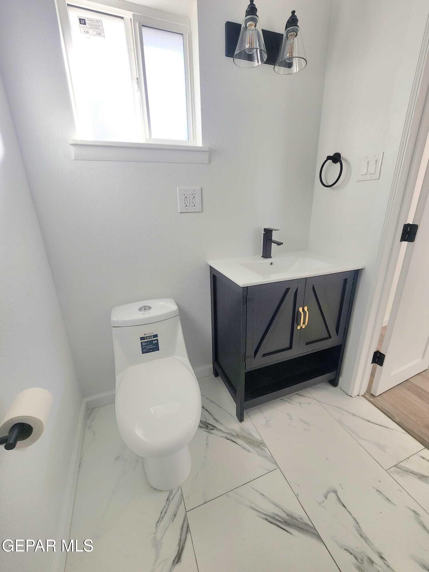 5845 Threadgill Avenue El Paso, TX 79924 - Photo 35 of 50 a bathroom with a toilet sink and mirror
