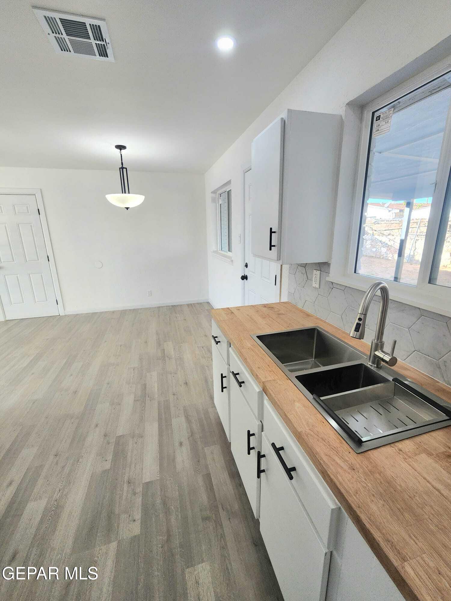 5845 Threadgill Avenue El Paso, TX 79924 - Photo 9 of 50 a kitchen that has a sink and a stove