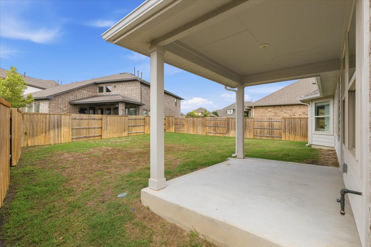 366 Cold Riv Run Kyle, TX 78640 - Photo 22 of 31 Covered patio with a concrete slab, overlooking a fenced backyard