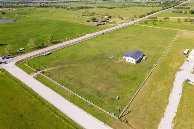 a view of a large building with a field