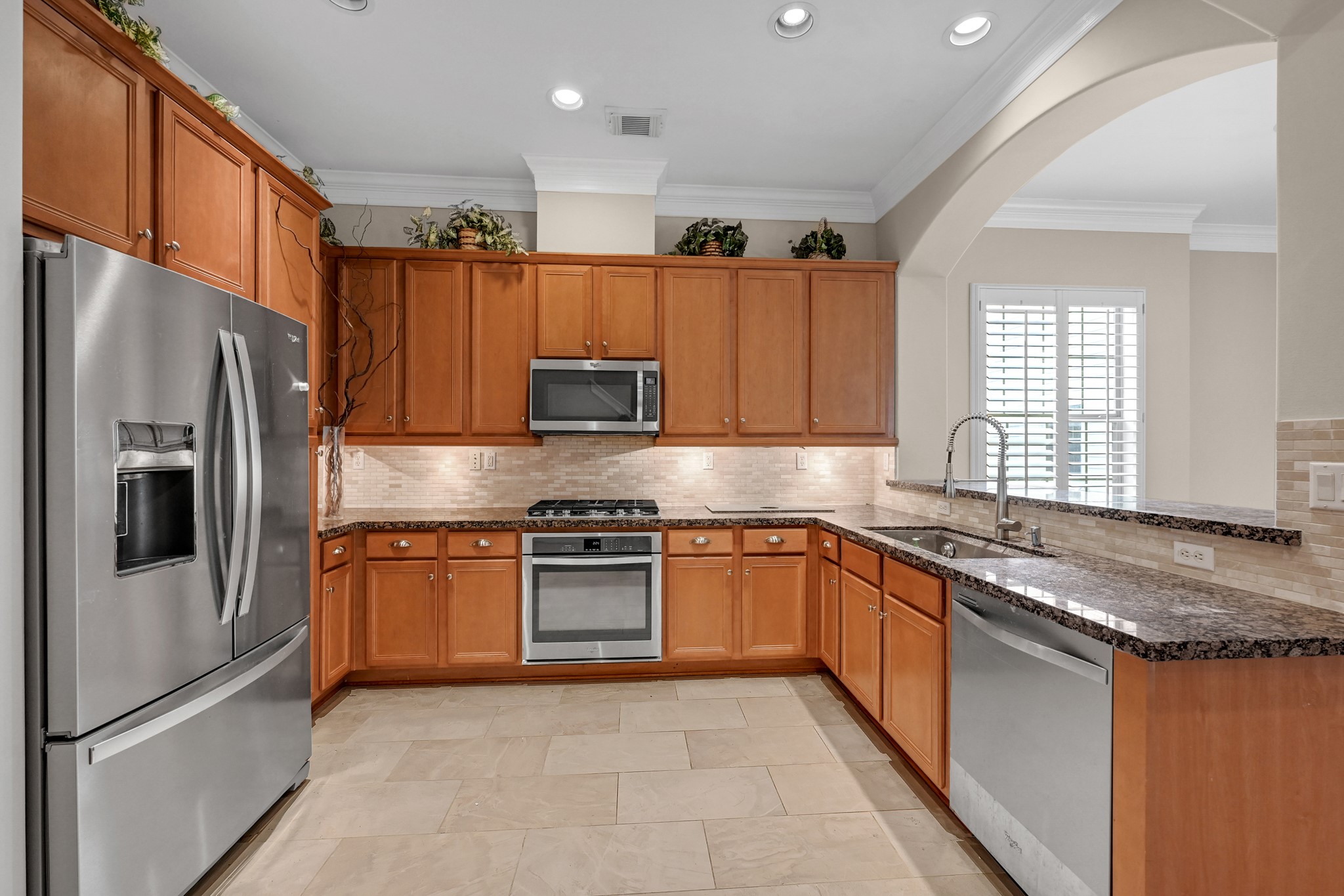 1204 Cohn Street Houston, TX 77007 - Photo 9 of 25 a kitchen with stainless steel appliances granite countertop a refrigerator stove microwave and sink