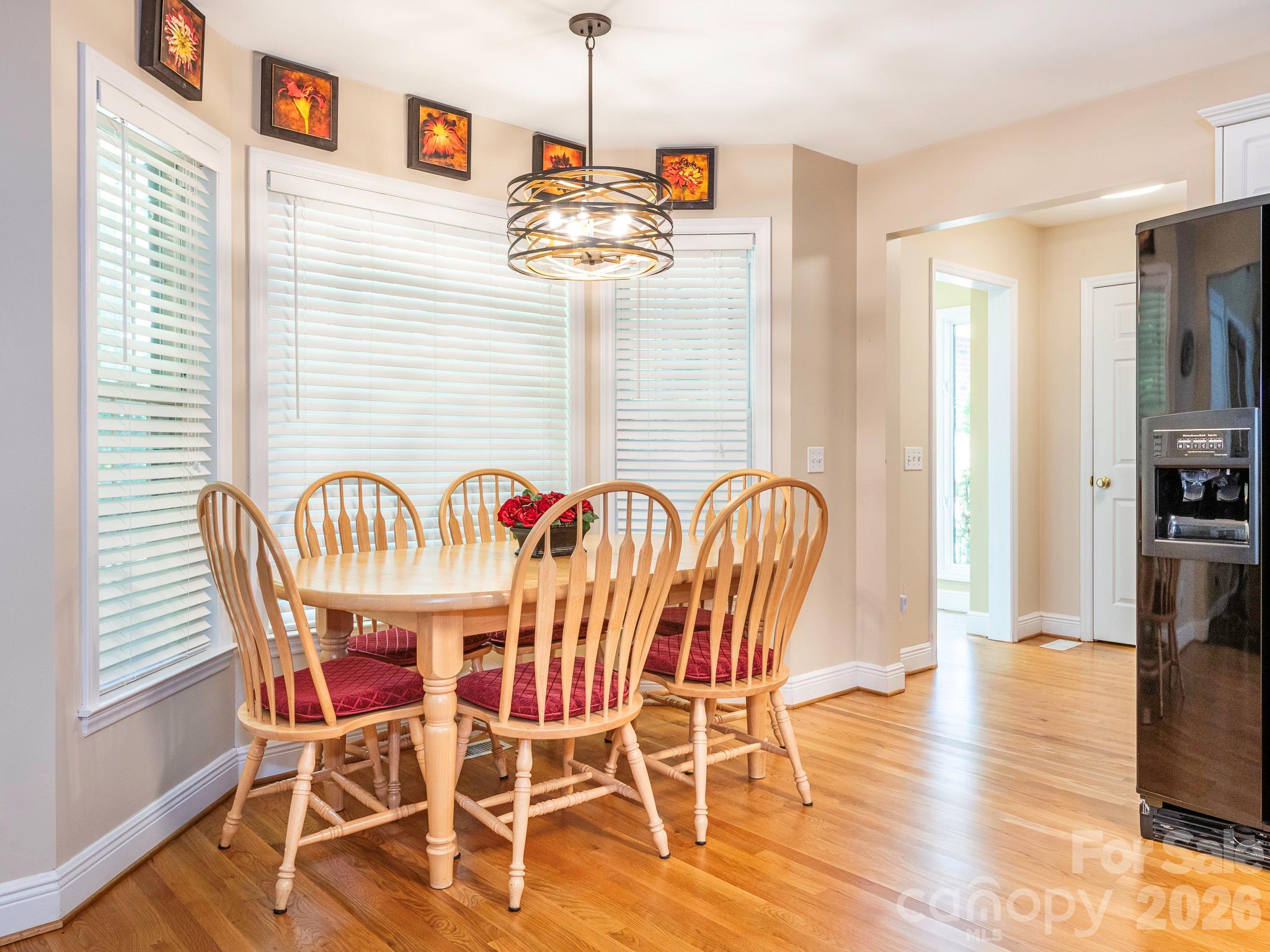 4440 Hucks Road Charlotte, NC 28269 - Photo 17 of 45 a dining room with furniture and wooden floor