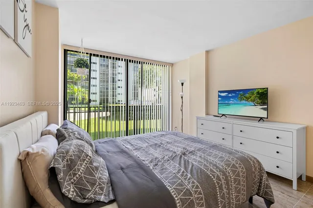 a spacious bathroom with a toilet a sink and mirror