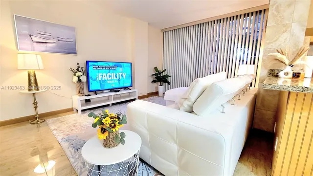 a living room with furniture and a flat screen tv