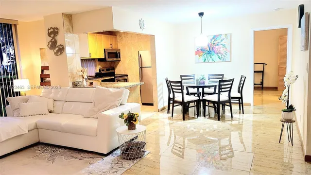 a living room with furniture wooden floor and dining table