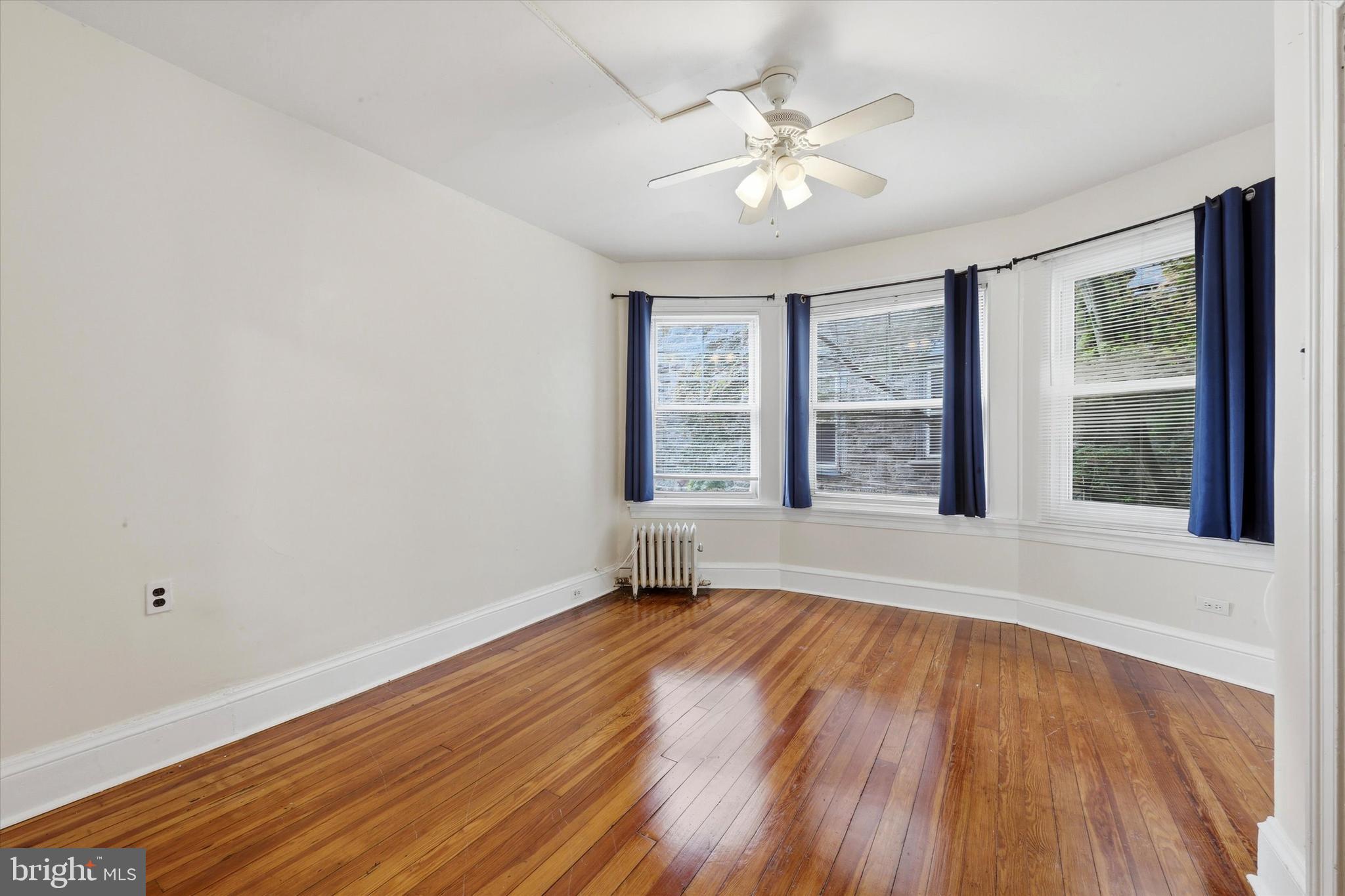 2044 North 63rd Street Philadelphia, PA 19151 - Photo 17 of 26 a view of an empty room with wooden floor and a window