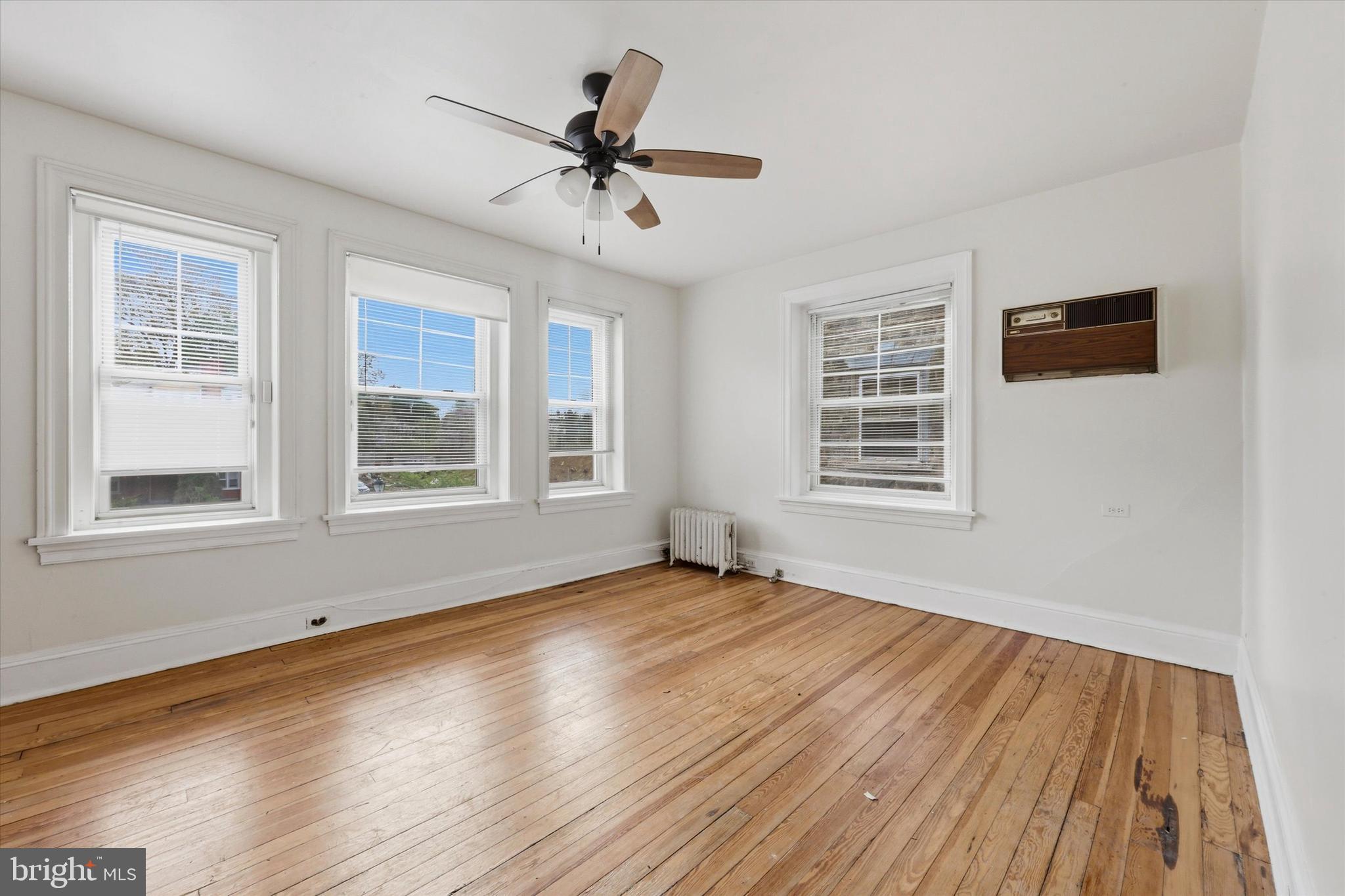 2044 North 63rd Street Philadelphia, PA 19151 - Photo 18 of 26 a view of an empty room with wooden floor and a window