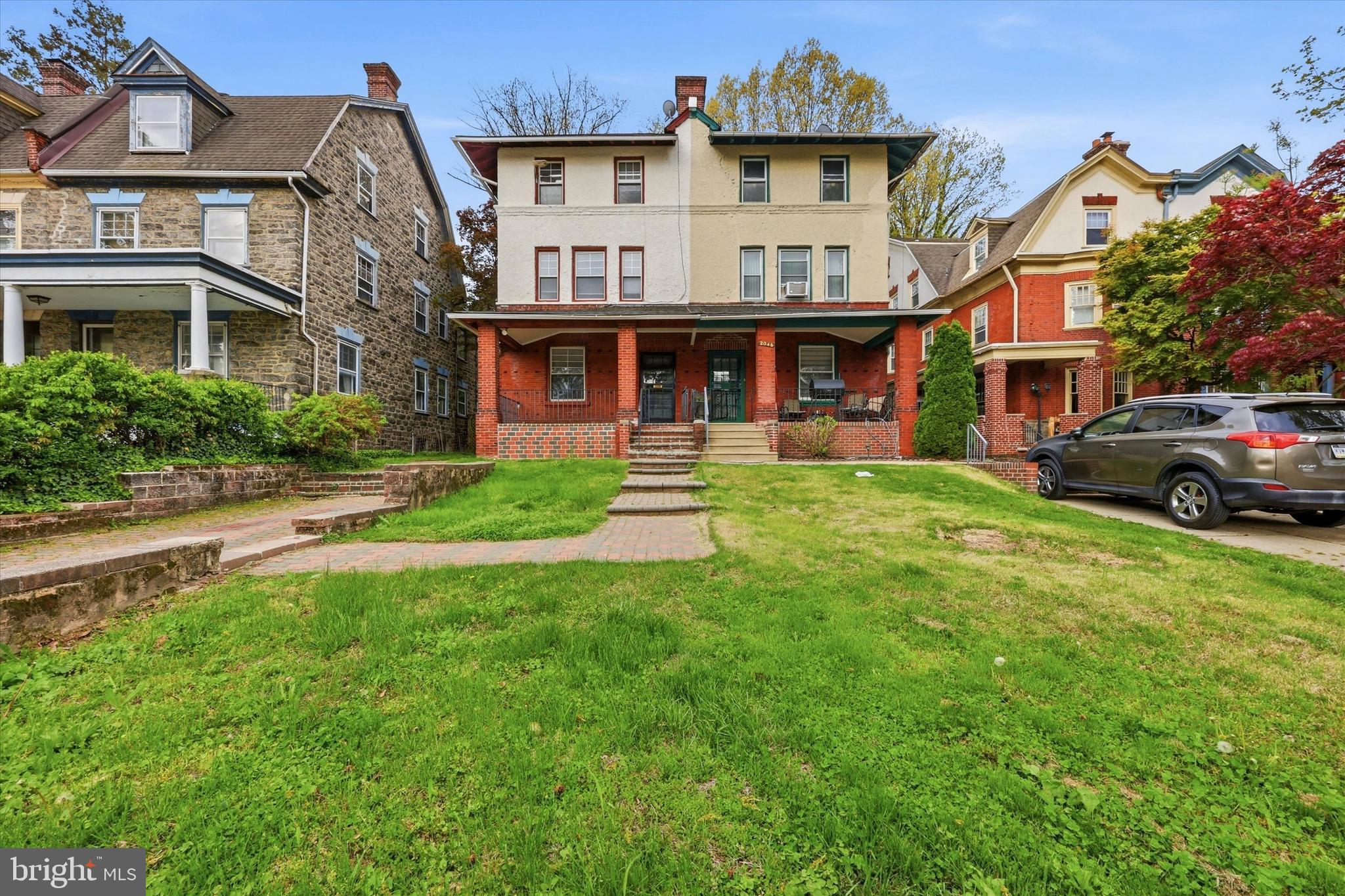 2044 North 63rd Street Philadelphia, PA 19151 - Photo 2 of 26 a view of a big house with a big yard and large trees