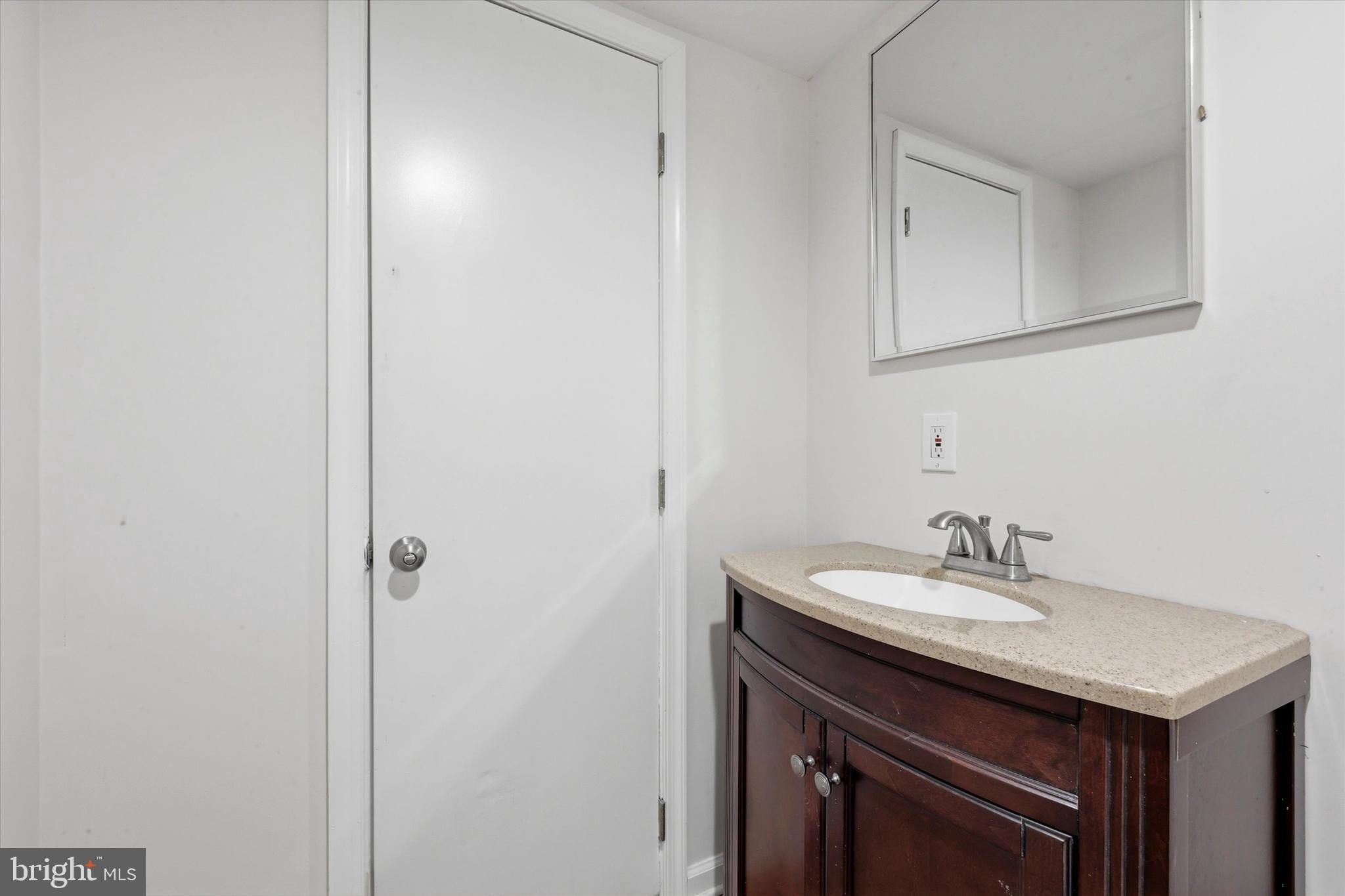 2044 North 63rd Street Philadelphia, PA 19151 - Photo 23 of 26 a bathroom with a sink and a mirror