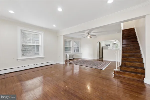 a view of entryway and hall with wooden floor