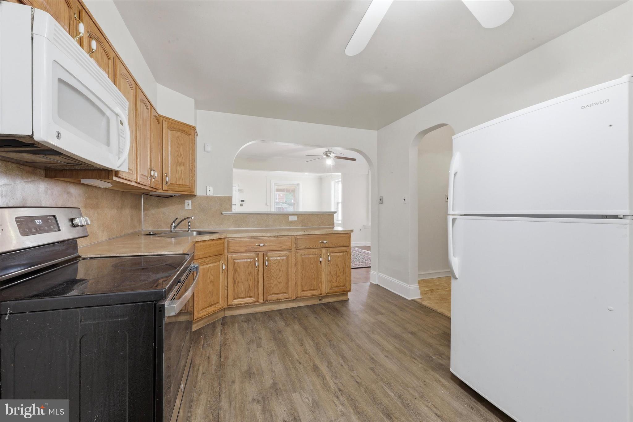 2044 North 63rd Street Philadelphia, PA 19151 - Photo 9 of 26 a kitchen with a refrigerator and a stove top oven