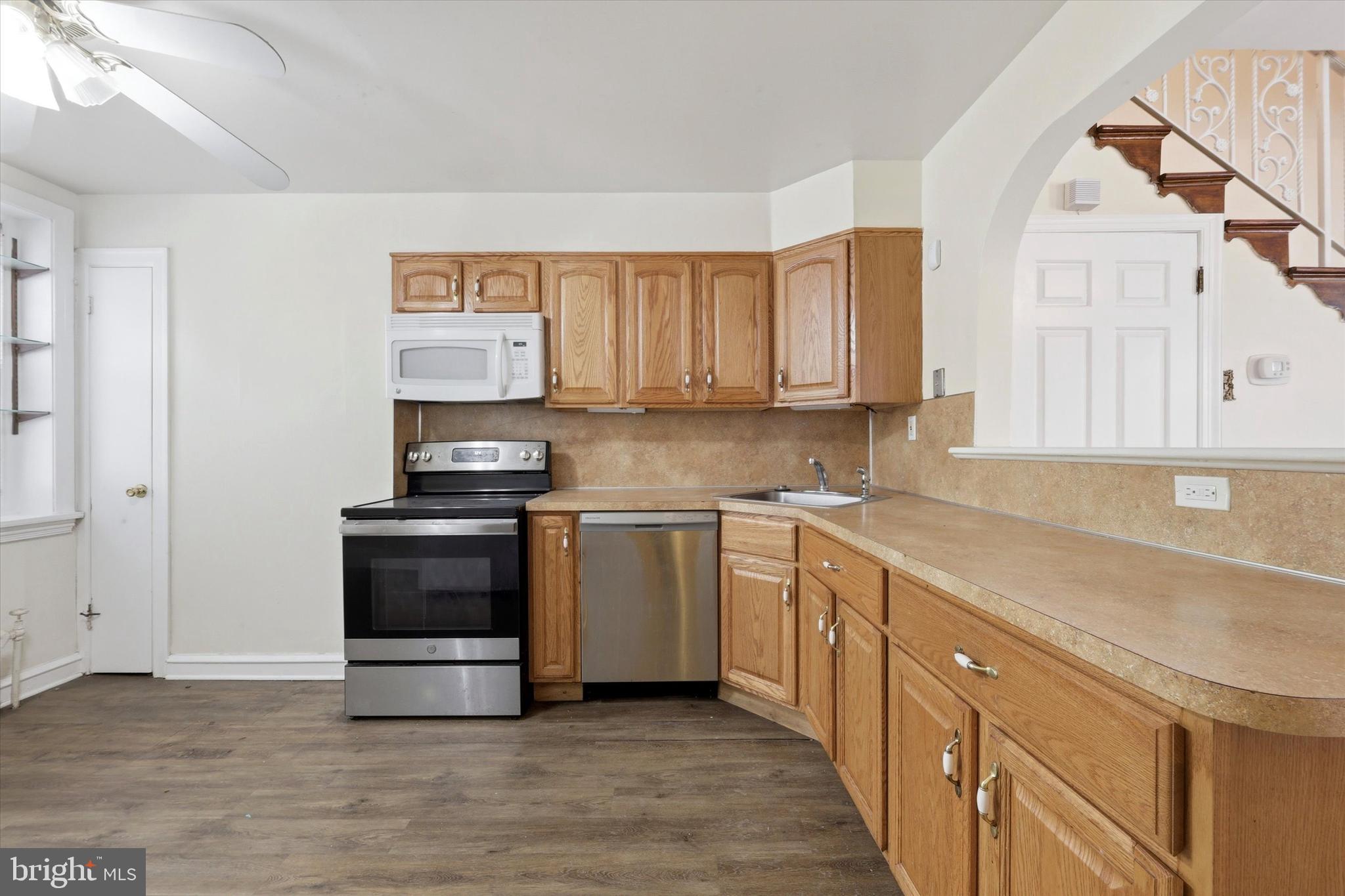 2044 North 63rd Street Philadelphia, PA 19151 - Photo 10 of 26 a kitchen with stainless steel appliances granite countertop a stove and a sink