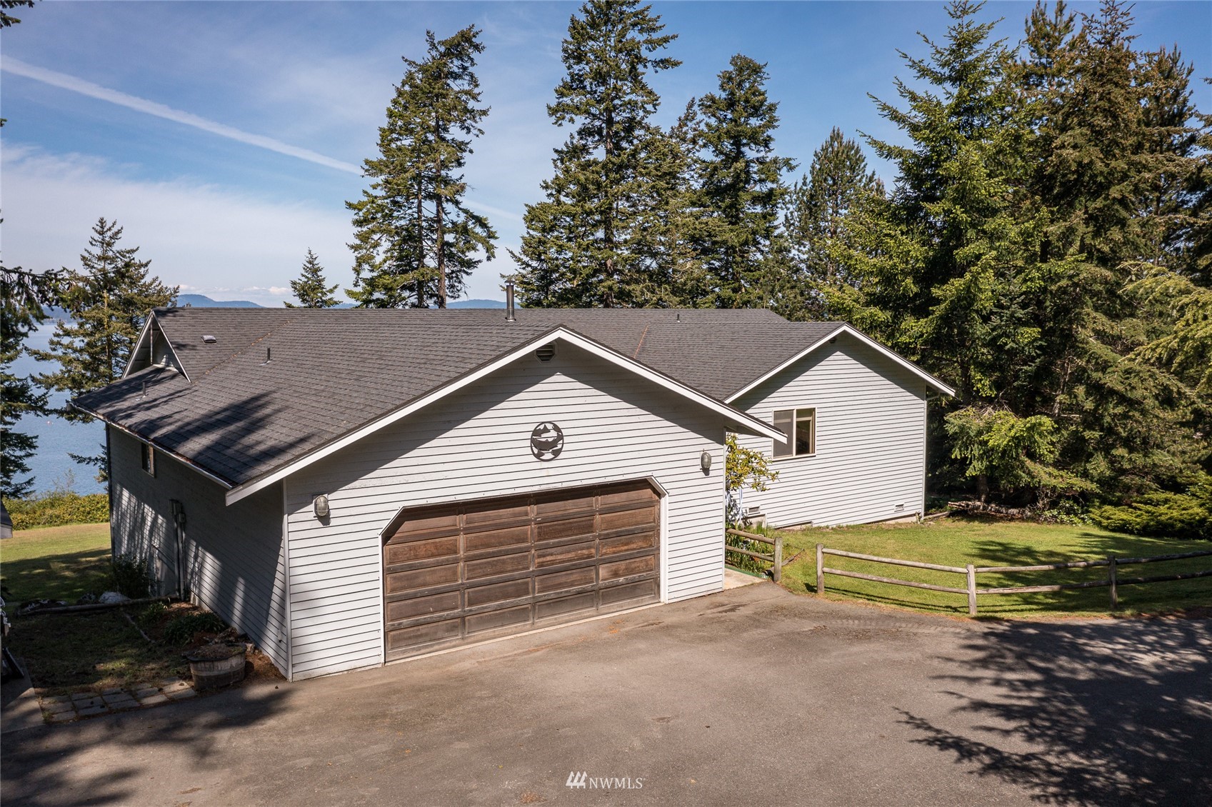 1384 Channel Road Lopez Island, WA 98261 - Photo 1 of 40 a front view of a house with a yard and garage