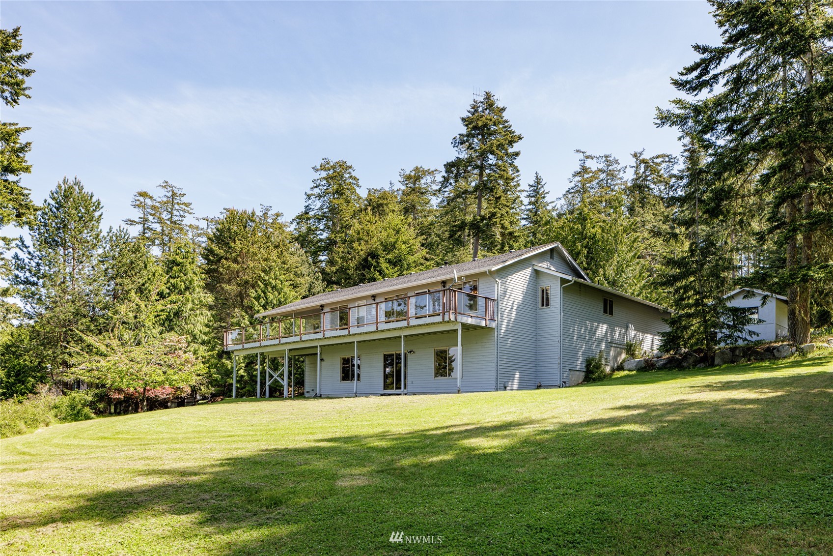 1384 Channel Road Lopez Island, WA 98261 - Photo 29 of 40 a front view of house with yard and trees in the background