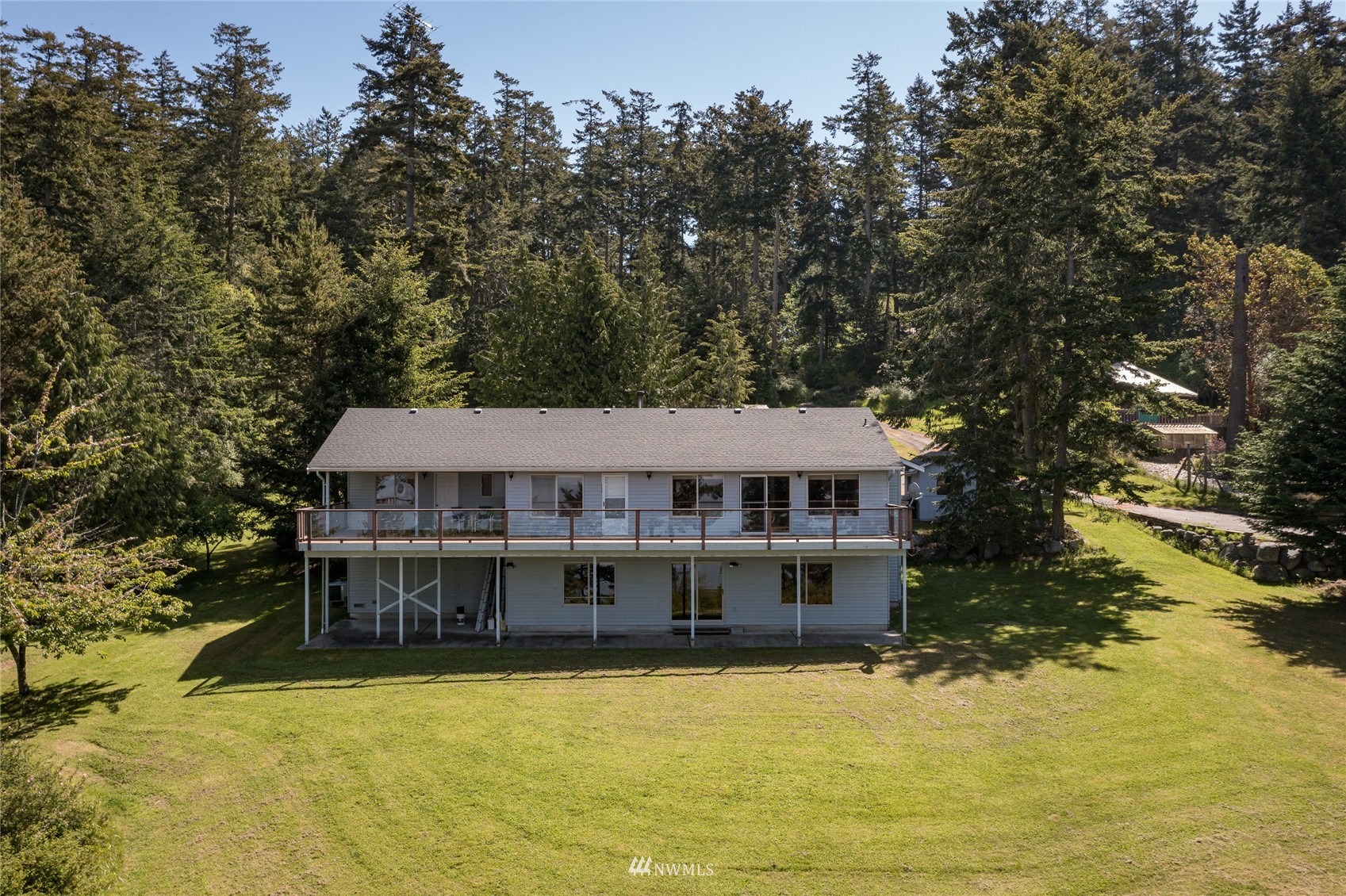 1384 Channel Road Lopez Island, WA 98261 - Photo 30 of 40 a view of a house with pool plants and large trees