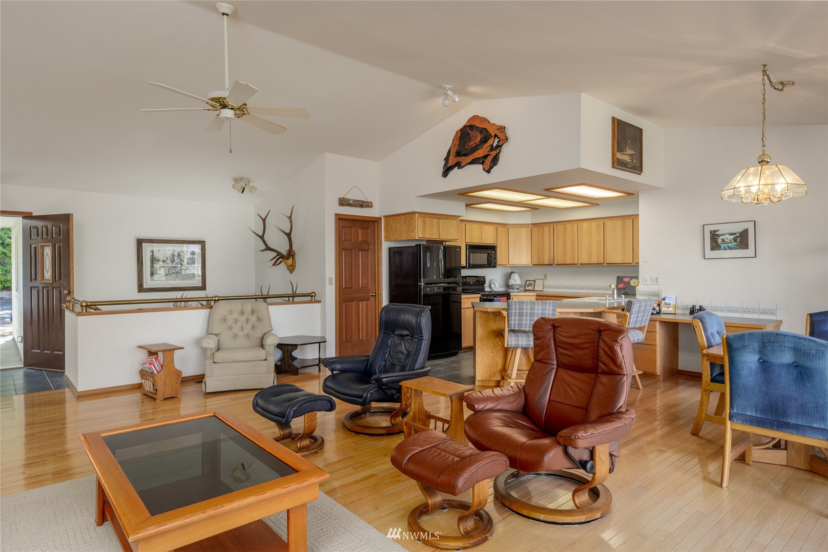 1384 Channel Road Lopez Island, WA 98261 - Photo 4 of 40 a living room with furniture a flat screen tv and kitchen view