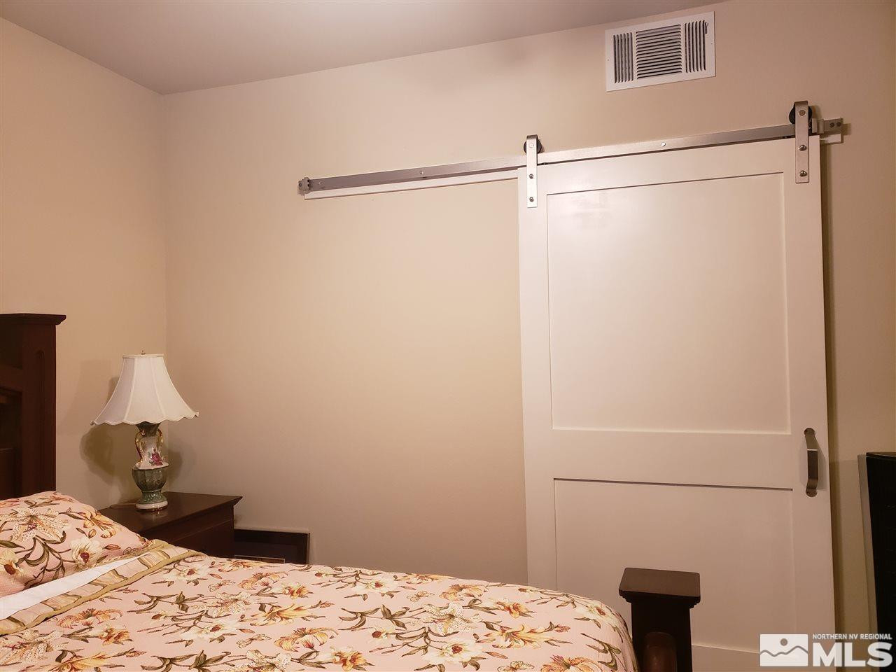 1325 South Meadows Parkway, Unit 311 Reno, NV 89521 - Photo 15 of 37 a bedroom with a bed and a window