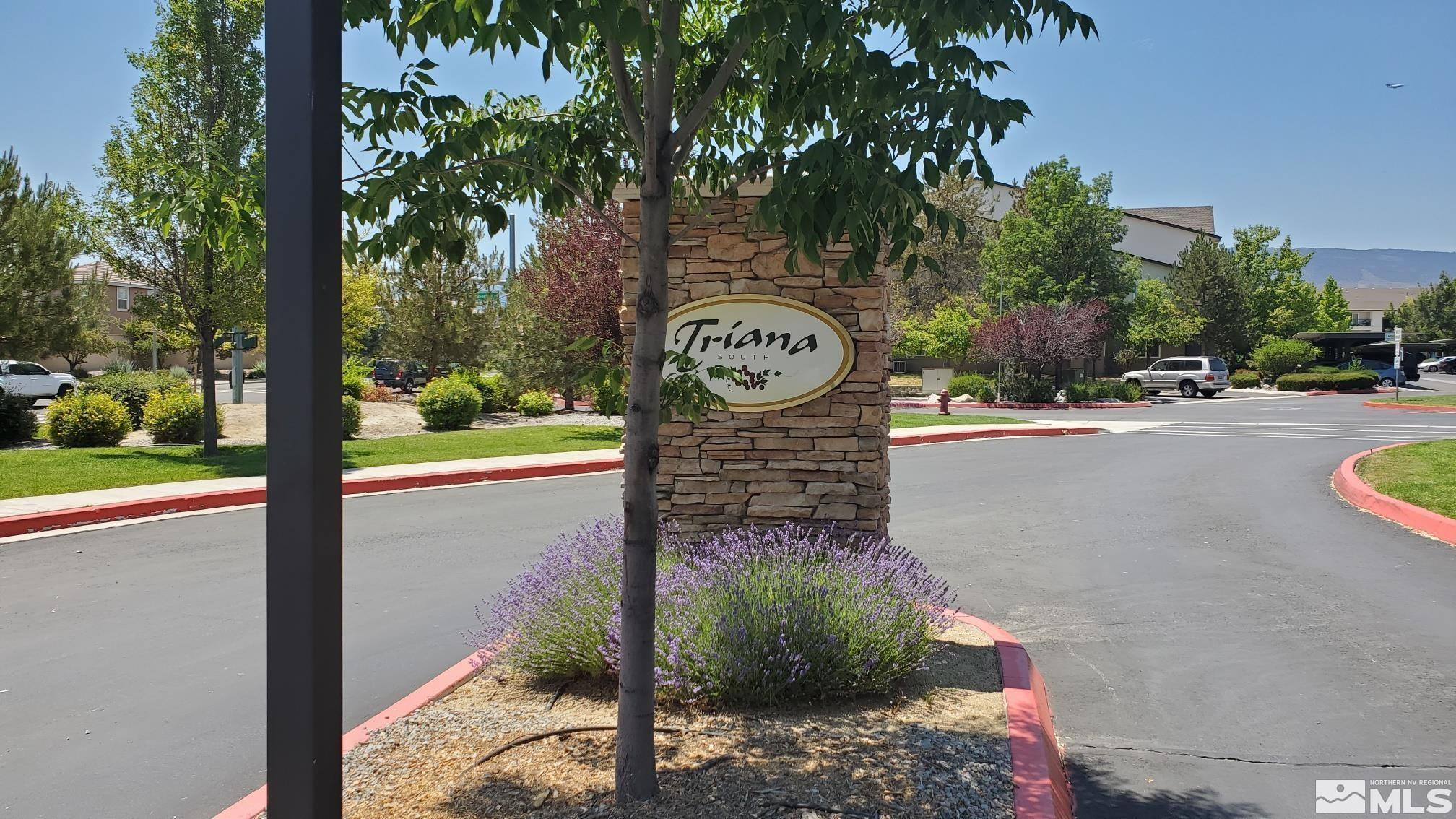1325 South Meadows Parkway, Unit 311 Reno, NV 89521 - Photo 2 of 37 a view of a street with a bench next to a road