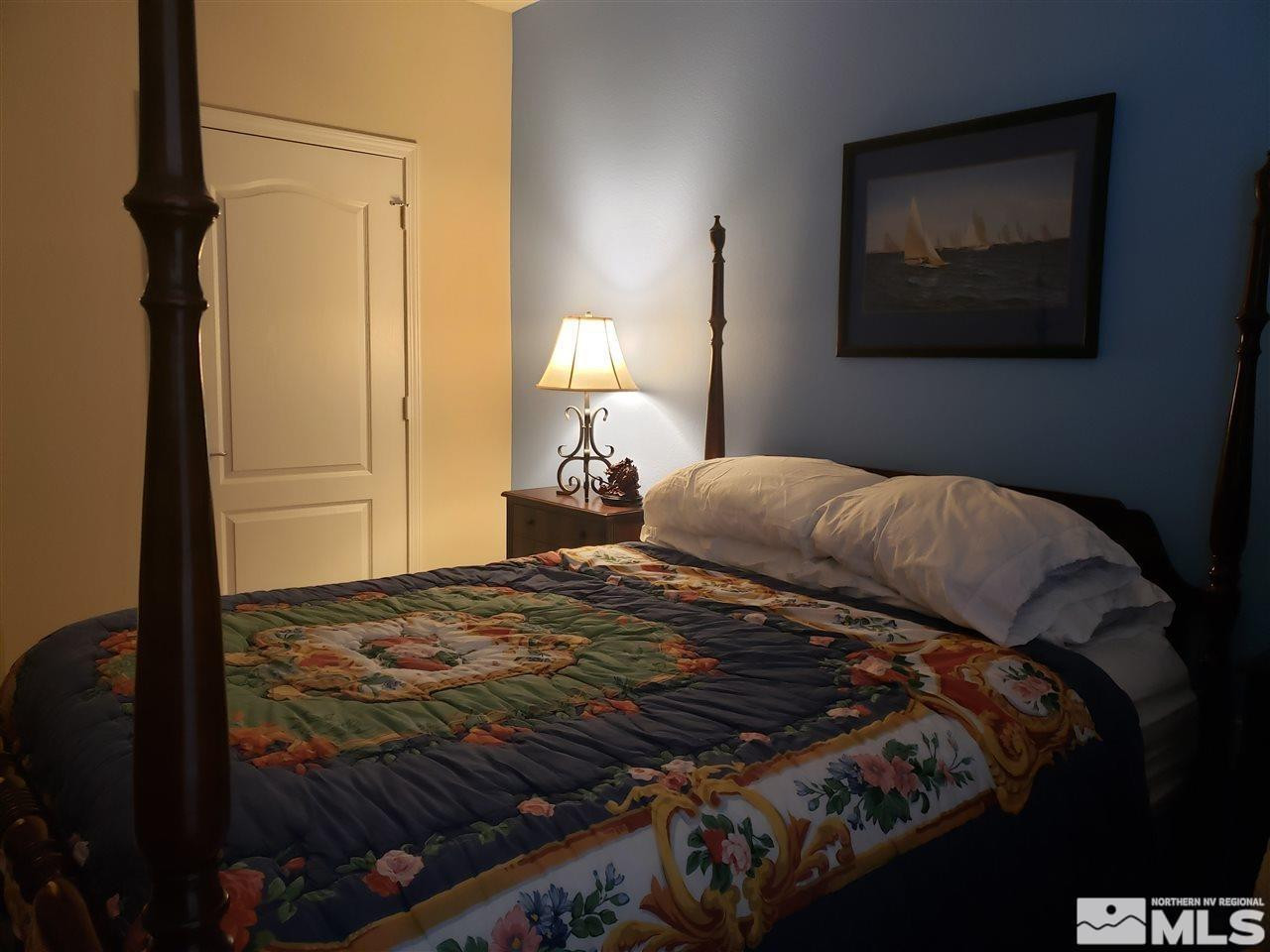 1325 South Meadows Parkway, Unit 311 Reno, NV 89521 - Photo 22 of 37 a bedroom with a bed and a painting on the wall