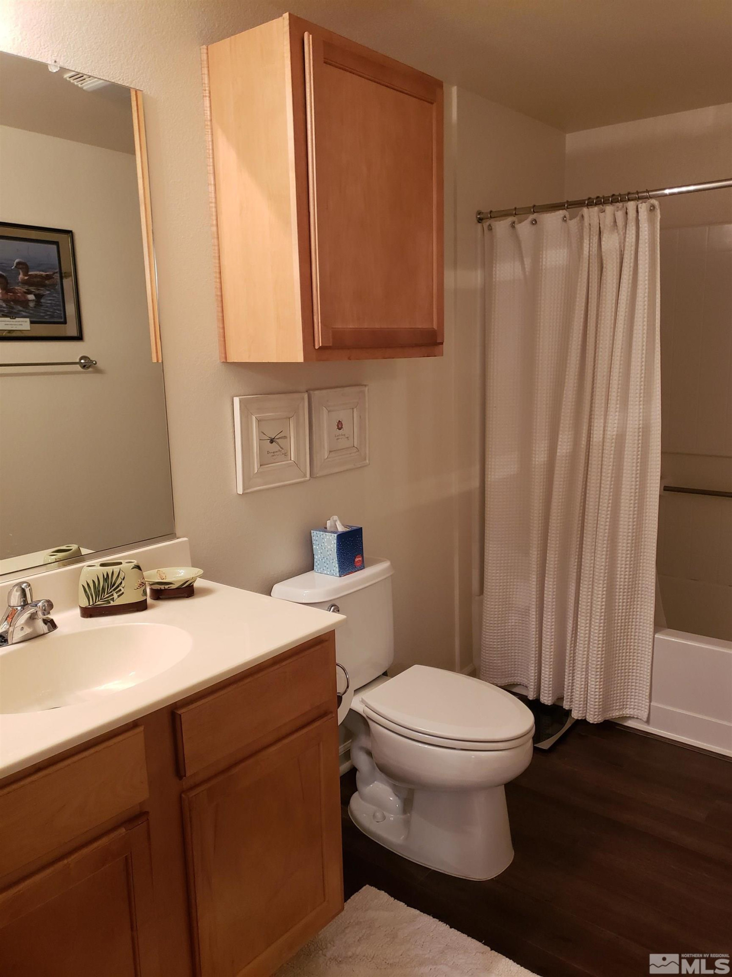 1325 South Meadows Parkway, Unit 311 Reno, NV 89521 - Photo 24 of 37 a bathroom with a sink a toilet and a mirror