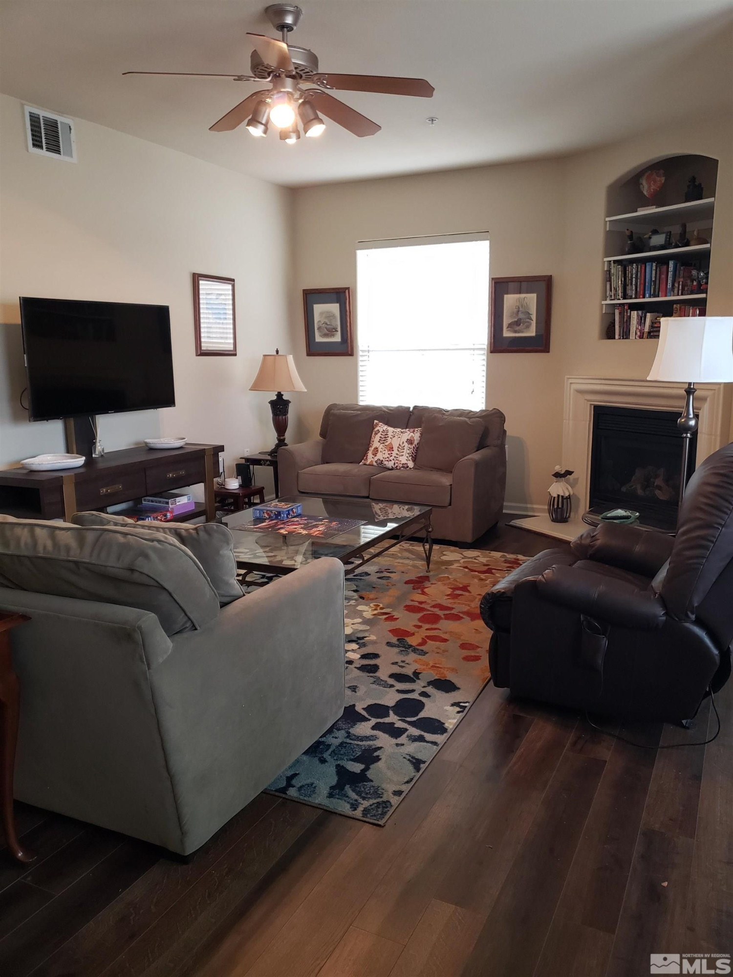 1325 South Meadows Parkway, Unit 311 Reno, NV 89521 - Photo 3 of 37 a living room with furniture fireplace and a flat screen tv