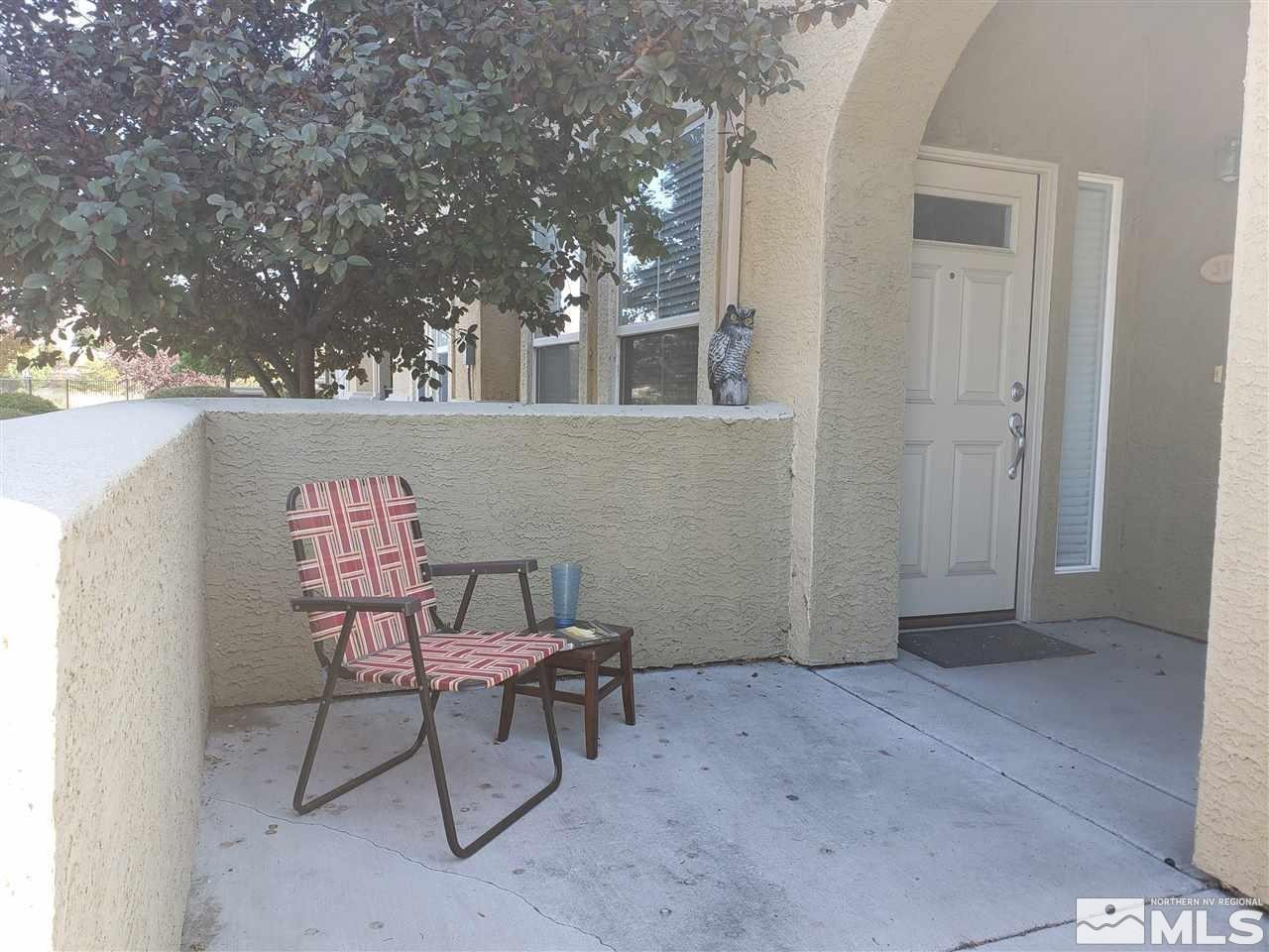 1325 South Meadows Parkway, Unit 311 Reno, NV 89521 - Photo 34 of 37 a view of a chairs and tables in the back yard of the house