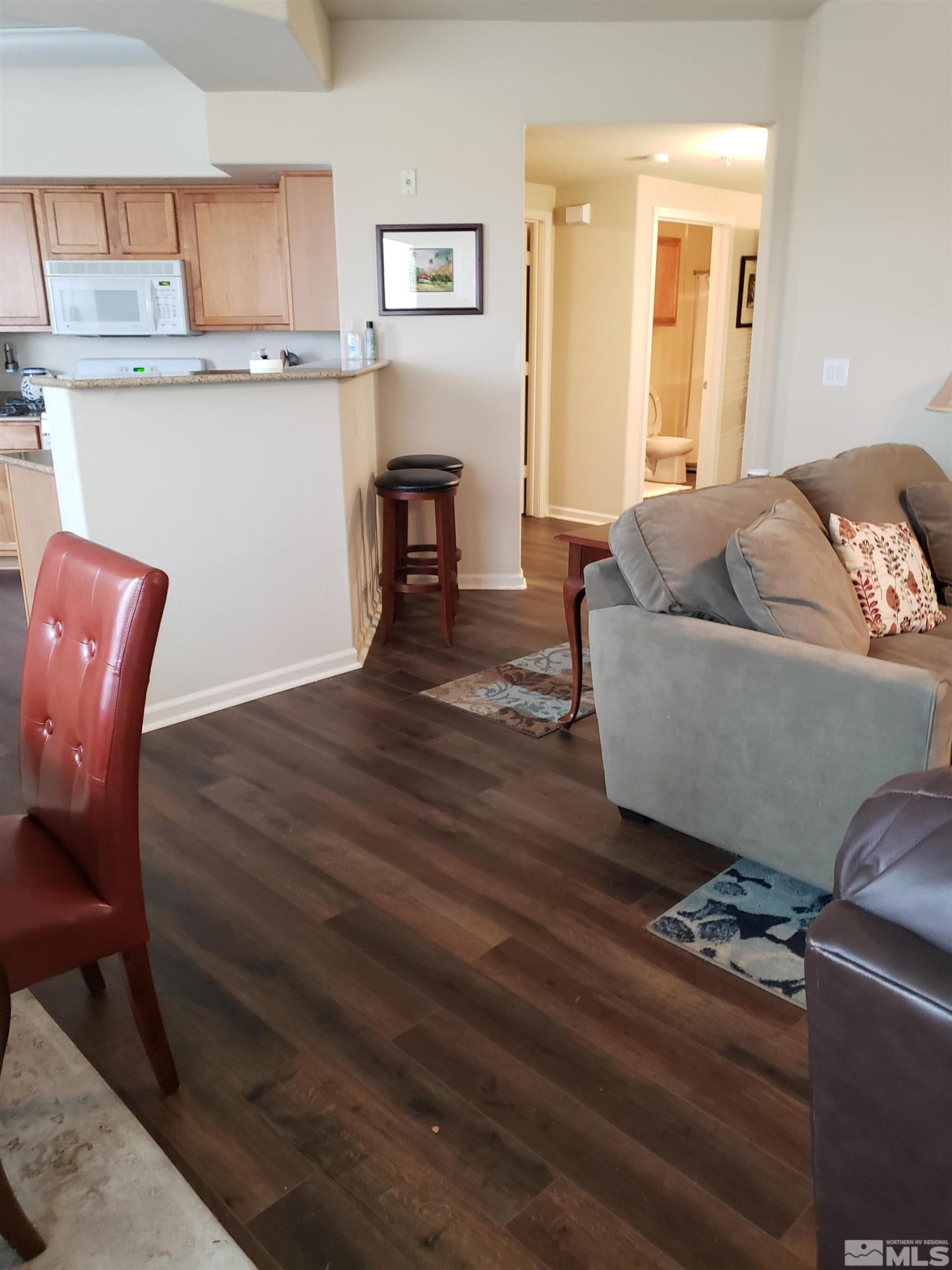 1325 South Meadows Parkway, Unit 311 Reno, NV 89521 - Photo 5 of 37 a living room with furniture and a table