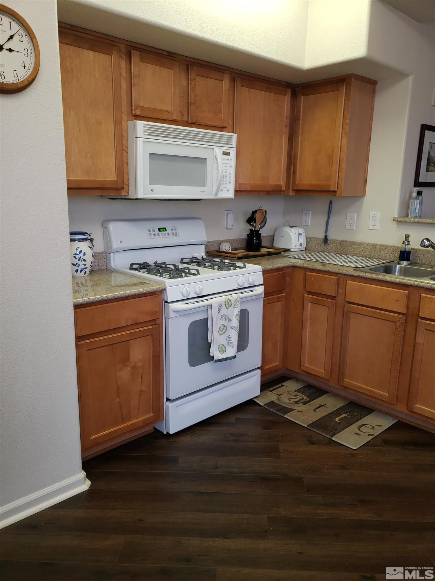 1325 South Meadows Parkway, Unit 311 Reno, NV 89521 - Photo 10 of 37 a kitchen with stainless steel appliances granite countertop a stove a sink and a microwave