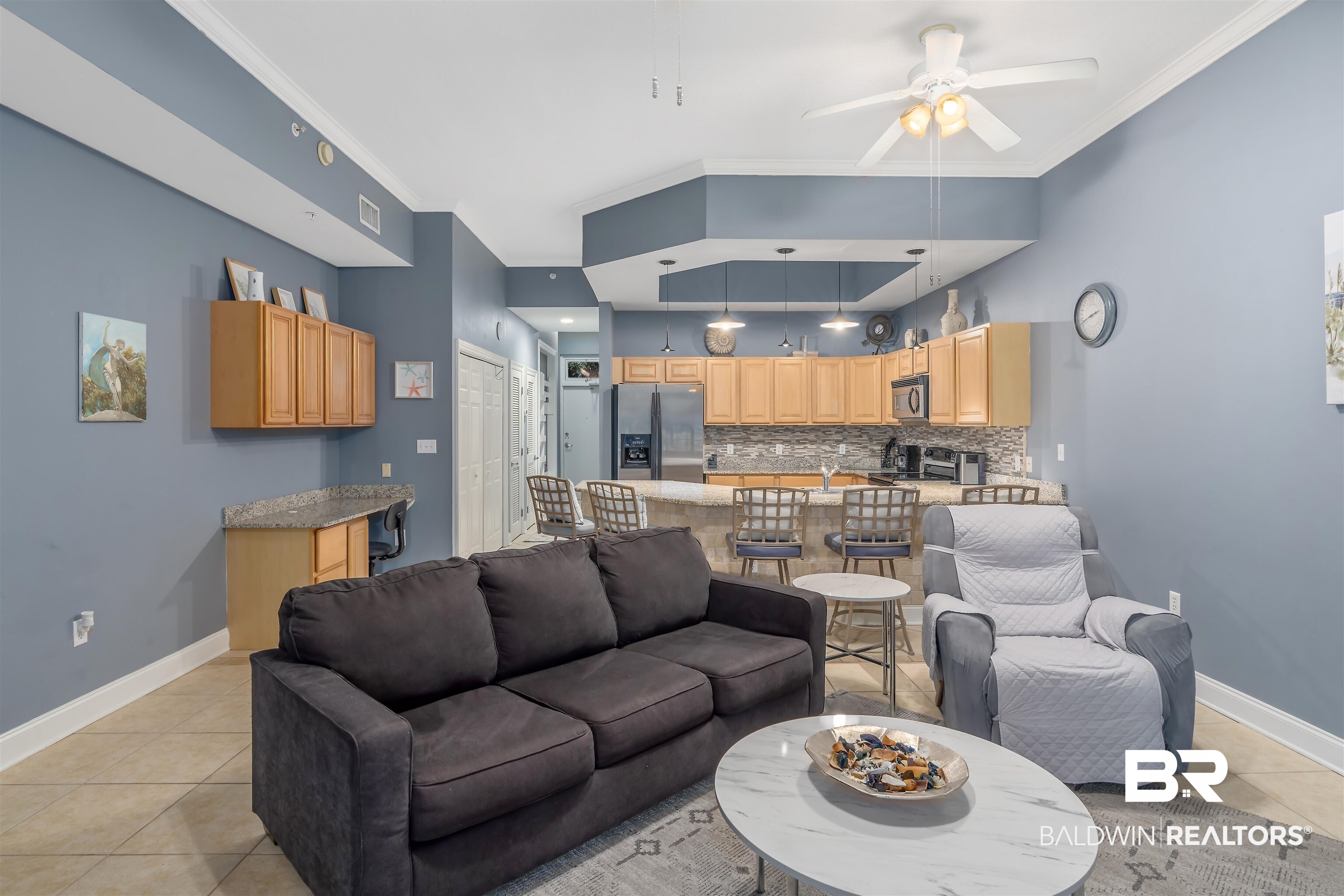 27800 Canal Road, Unit 113 Orange Beach, AL 36561 - Photo 9 of 35 Living room with light tile patterned floors, ceiling fan, and ornamental molding