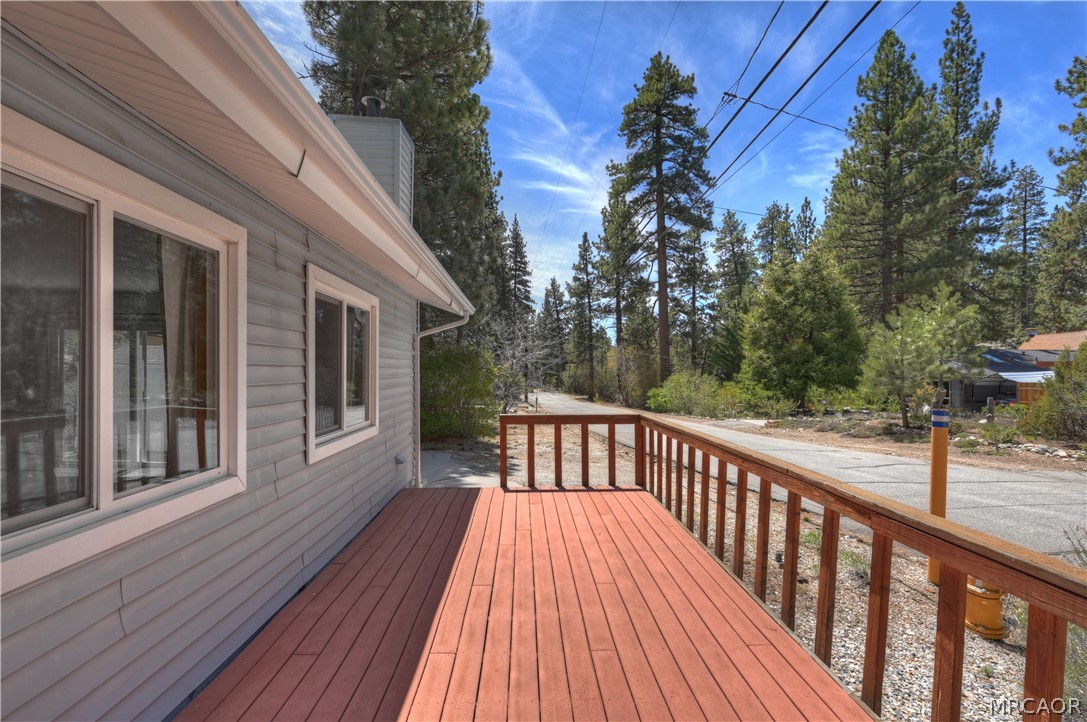 1099 Canyon Road Fawnskin, CA 92333 - Photo 33 of 39 a view of a wooden deck with a yard