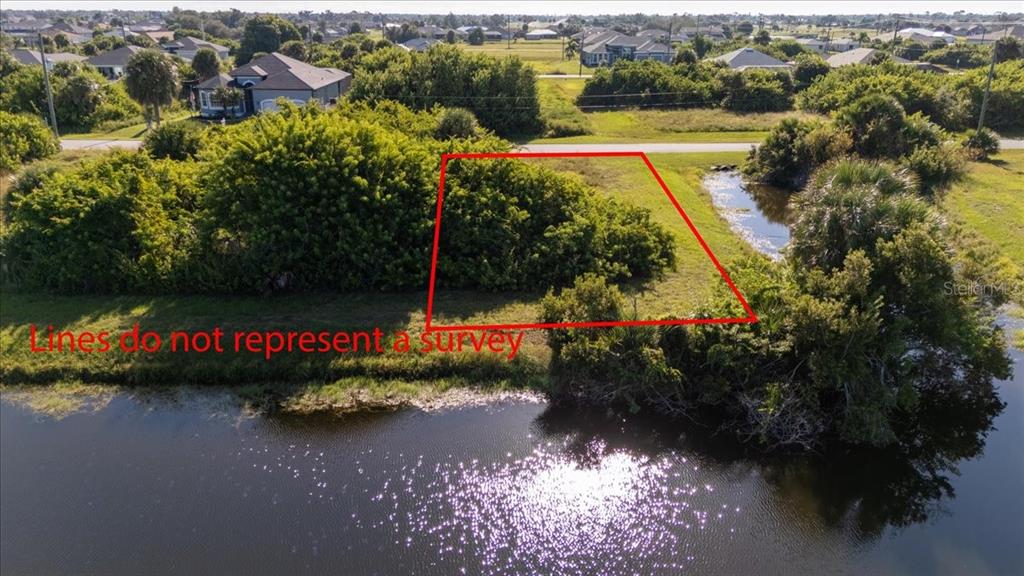 155 Spring Drive Rotonda West, FL 33947 - Photo 2 of 12 a view of a street with lots of trees and houses