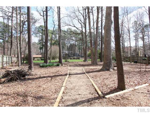 8816 Trailing Cedar Drive Raleigh, NC 27613 - Photo 18 of 24 a backyard of a house with lots of green space