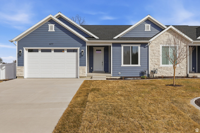 677 East 800 S Street Springville, UT 84663 - Photo 1 of 35 Ranch-style house with stone siding, driveway, a front yard, and an attached garage